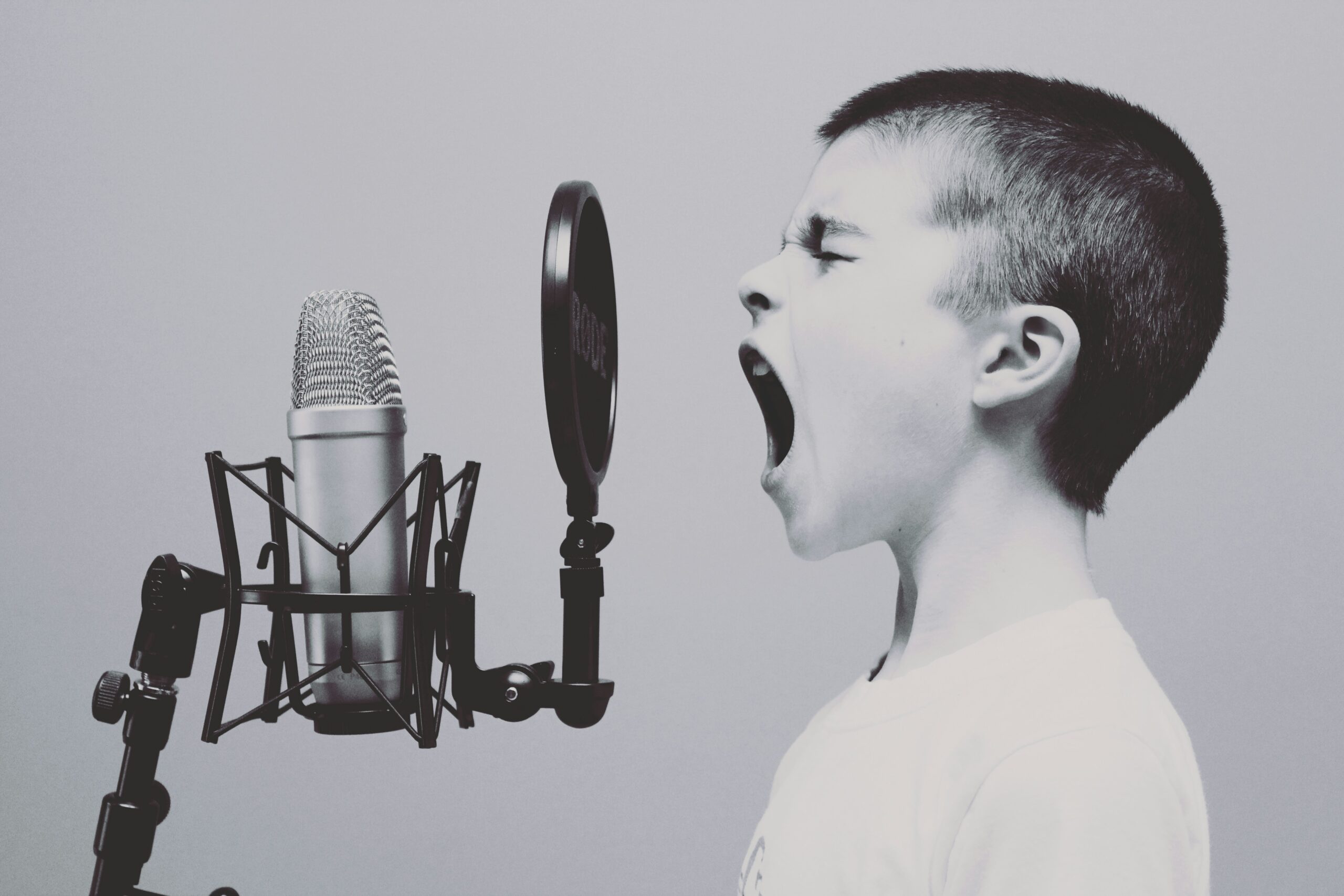 boy singing on microphone